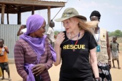 FILE - Human rights activist Mia Farrow talks with staff from the International Rescue Committee while visiting an internally displaced persons camp in Juba, South Sudan, April 2, 2019.