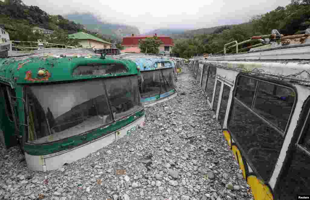 Damaged trolleybuses are seen after heavy rainfall and floods in Yalta, Crimea.