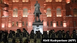 Law enforcement officers stand guard in front of a monument to Soviet Marshal Georgy Zhukov outside Red Square in Moscow, Russia on Feb. 2, 2021.