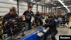 FILE - Workers construct mini-bikes at motorcycle and go-kart maker Monster Moto in Ruston, Louisiana, Jan. 25, 2017. 