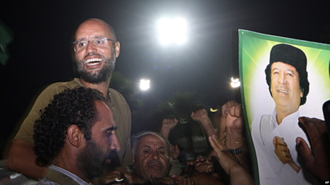 Seif al-Islam Gadhafi, top left, gestures to troops loyal to his father in Tripoli, Libya, August 23, 2011 (file photo).