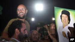 Seif al-Islam Gadhafi, top left, gestures to troops loyal to his father in Tripoli, Libya, August 23, 2011 (file photo).