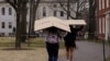 FILE - Students carry boxes to their dorms at Harvard University, after the school asked its students not to return to campus after Spring Break, March 10, 2020, in Cambridge, Massachusetts, U.S. 