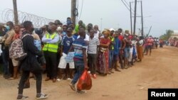 People wait for friends and relatives as a ship carrying more than 1,000 people fleeing an attack claimed by Islamic State-linked insurgents on the town of Palma, docks in Pemba, Mozambique, Apr. 1, 2021. 