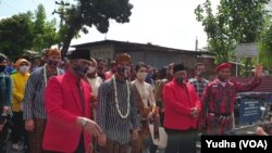 Iring-iringan bakal pasangan calon dari jalur partai politik, Gibran Rakabuming Raka ( depan memakai masker- baju lurik bergaris) didampingi ketua DPC PDIP Solo, Hadi Rudyatmo (4 dari kiri- depan berjas merah- masker) dan diikuti kandidat Wakil Walikota, 