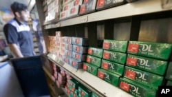 FILE - Packs of menthol cigarettes and other tobacco products line shelves at a store in San Francisco, May 17, 2018.