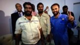 Three foreign oil workers kidnapped by rebels in South Sudan smile as they arrive after being released at Khartoum Airport, Sudan, March 30, 2017.