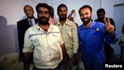 Three foreign oil workers kidnapped by rebels in South Sudan smile as they arrive after being released at Khartoum Airport, Sudan, March 30, 2017.