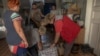 A woman receives humanitarian food assistance for herself and to distribute it among residents in the town of Siversk, located around 8 kilometers from the frontline in the eastern Donetsk region, on August 6, 2024, amid the Russian invasion of Ukraine.