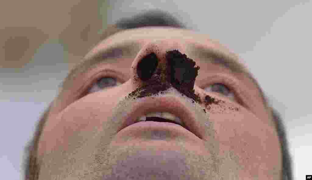 A competitor awaits the judges after he took snuff at the German Snuff Championships in Freihung near Nuremberg, southern Germany, June 8, 2013. The competition&#39;s aim is to snuff as much as possible from a five gram snuff package.