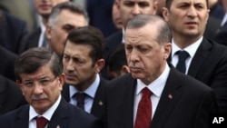 FILE - Turkey's President Recep Tayyip Erdogan (R) and Prime Minister Ahmet Davutoglu (L) arrive to attend funeral prayers in Sur, Diyarbakir, in Ankara, Turkey, Feb. 18, 2016. 