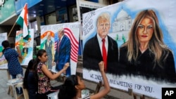Children from an art school make paintings of U.S. President Donald Trump ahead of his India visit, in Mumbai, India, Feb. 21, 2020.