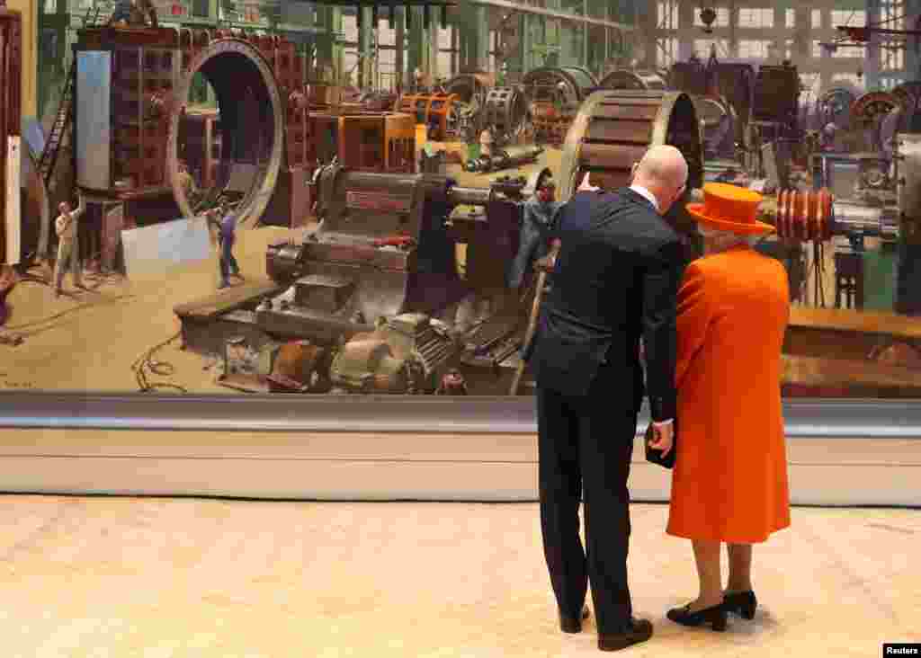 Britain&#39;s Queen Elizabeth views a painting with Science Museum Director Ian Blatchford during a visit to the museum in London.