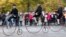 Participants wearing historical costumes ride their high-wheel bicycles during the annual penny farthing race in Prague, Czech Republic, Nov. 2, 2024, 