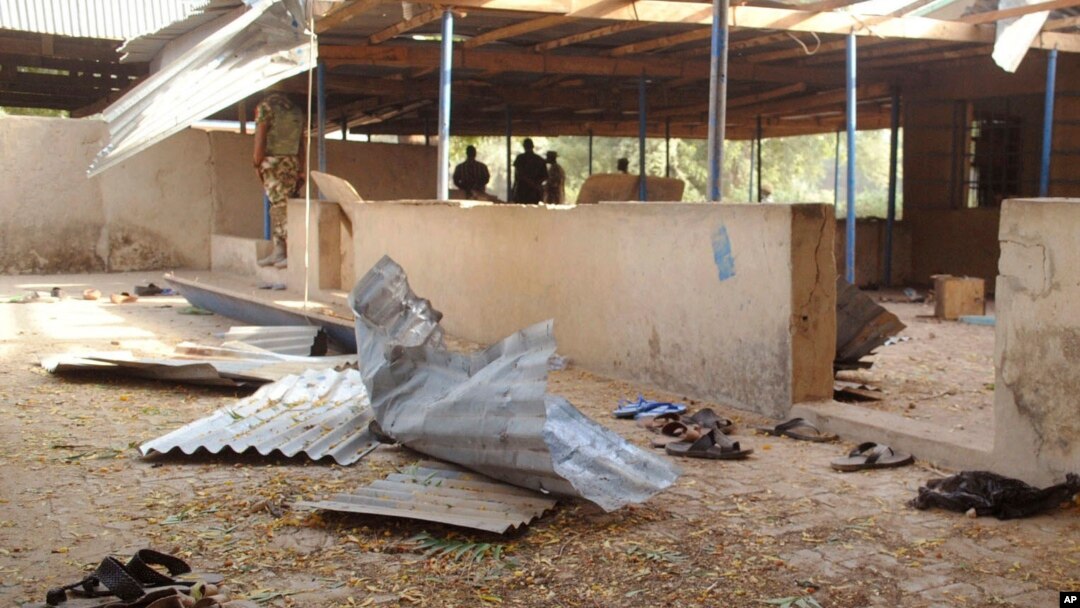 Nigeria troops, rear, provide security at the area where a bomb exploded in Nigeria's northeastern University of Maiduguri at Maiduguri, Nigeria, Jan. 16, 2016.