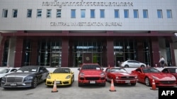 Rows of luxury cars seized from The iCon Group are seen at the Central Investigation Bureau in Bangkok on October 17, 2024. Police arrested 18 people, including three celebrities, and seized luxury cars and millions of dollars in connection with a pyramid scheme, officers said.