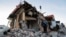 Local residents remove debris and carry belongings out of a shop destroyed in recent shelling in the course of Russia-Ukraine conflict in Donetsk, Russian-controlled Ukraine, Jan. 10, 2023. 