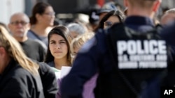 FILE - People line up to cross into the United States from Tijuana, Mexico, at the San Ysidro port of entry in San Diego, Nov. 19, 2018. 