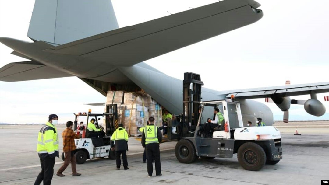 A handout picture released by the World Health Organization (WHO) on March 2, 2020, shows the unloading of medical equipment and coronavirus testing kits upon their arrival at Mehrabad International Airport in Iran's capital Tehran.