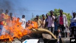 Anti-government protesters burn photographs of President Mohamed Abdullahi Mohamed, also known as Farmajo, in the Fagah area of Mogadishu, Somalia, April 25, 2021. 