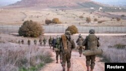 Israeli Paratroopers' Brigade members operate in a location given as the Syrian border, in this handout picture released on Dec. 13, 2024. (Israel Defense Forces/Handout via Reuters)