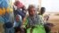 FILE - A family of refugees that fled their homes due to violence from the Islamic extremist group Boko Haram sit inside a refugee camp in Minawao, Cameroon, Feb. 25, 2015.