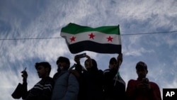 Syrians gather in celebration days after the fall of Bashar al-Assad's government at Umayyad Square in Damascus, Dec. 12, 2024. 