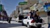 A convoy of police patrols in a market to enforce lockdown to help control the spread of the coronavirus, in Quetta, Pakistan, Sunday, May 9, 2021. (AP Photo/Arshad Butt)