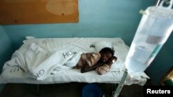 FILE - Mariam Dagane, who is infected with Rift Valley fever, rests on her bed at the Garissa hospital, 390 km (242 miles) from Nairobi, January 9, 2007.