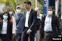 Al Jazeera staff leave the Bukit Aman police headquarters after being questioned by Malaysian police over a documentary about the arrests of undocumented migrants in the country, in Kuala Lumpur, Malaysia on July 10 2020.