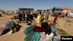 New arrivals, who fled from violence, stand near their belongings at the Teachers' Village IDP camp in Maiduguri, Nigeria, Jan. 16, 2019.