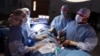  Dr. Keith Melancon, right, Georgetown's kidney transplant director, performs the surgery to harvest the kidney from donor Tom Otten, at Georgetown University Hospital in Washington.