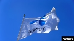 FILE - Telenor flag flutters next to the company's headquarters in Fornebu, Norway, June 1, 2017.