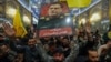 People lift a portrait of Iran's Islamic Revolutionary Guards Corps' slain commander Abbas Nilforushan during his funeral procession at the Imam Hussein shrine in Iraq's holy central city of Karbala, Oct. 14, 2024.