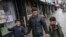 FILE - Sadek Ahmed walks with his sons Adel, 9, right, and Mutaz, 7, in New York, March 21, 2019. Their mother is stuck in Yemen with her two younger sons, the boys’ brothers. Their situation is representative of the toll the travel ban has on families.