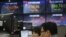 Currency traders watch monitors at the foreign exchange dealing room of the KEB Hana Bank headquarters in Seoul, South Korea, March 13, 2020.