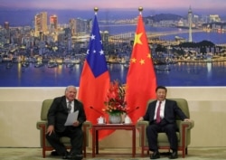 FILE - Samoa's then-prime minister, Tuila’epa Sa’ilele Malielegaoi, meets with China's President Xi Jinping at the Great Hall of the People in Beijing, Sept. 18, 2018.