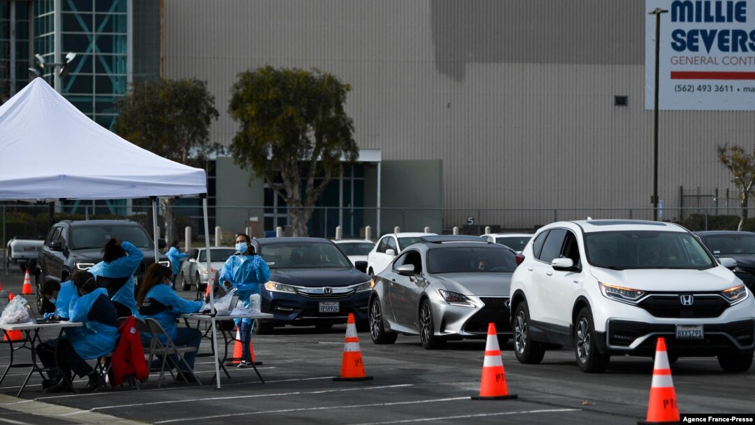 Vehicles wait in line to receive Covid-19 PCR tests at a Long Beach Public Health Department testing site in the parking lot of a former Boeing aircraft factory on Jan. 10, 2022 in Long Beach, California. 