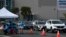 Vehicles wait in line to receive Covid-19 PCR tests at a Long Beach Public Health Department testing site in the parking lot of a former Boeing aircraft factory on Jan. 10, 2022 in Long Beach, California. 
