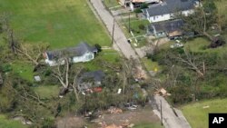 Árboles caídos y escombros rodean casas dañadas por el huracán Laura el jueves, 27 de agosto de 2020 cerca de Lake Charles, Louisiana.