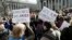 FILE - People hold anti-deportation signs during a rally, March 9, 2017, in New York. The rally was held in support of Ravi Ragbir, leader of the New Sanctuary Coalition, and an immigrant from Trinidad, who may face deportation. 