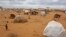 A child runs, left, at a refugee camp in Dadaab, Kenya, Aug 4, 2011.