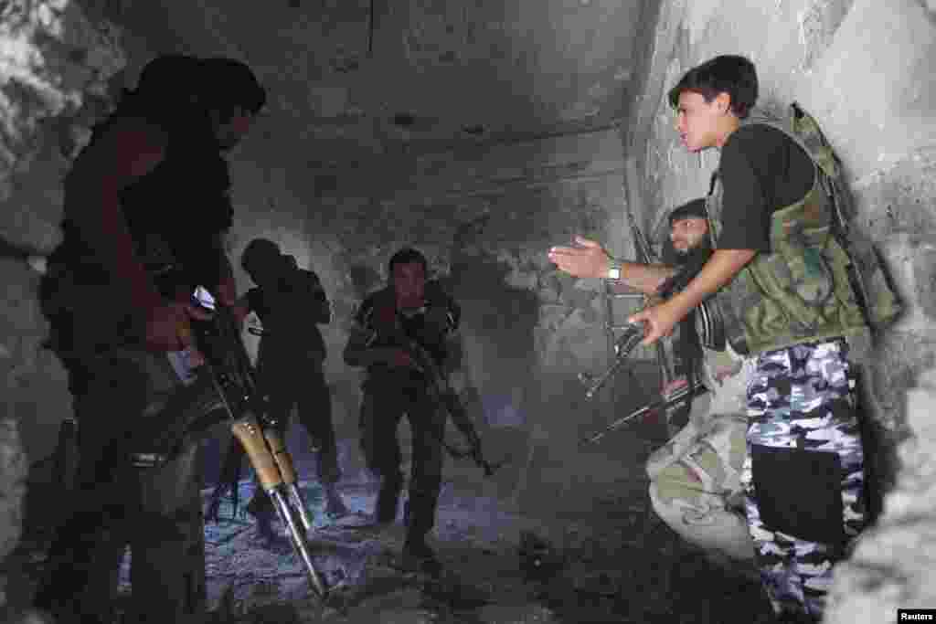 A Free Syrian Army commander reacts while taking cover inside a house during what activists said were clashes with forces loyal to Syria's President Bashar al-Assad in Deir al-Zor, Oct. 1, 2013.