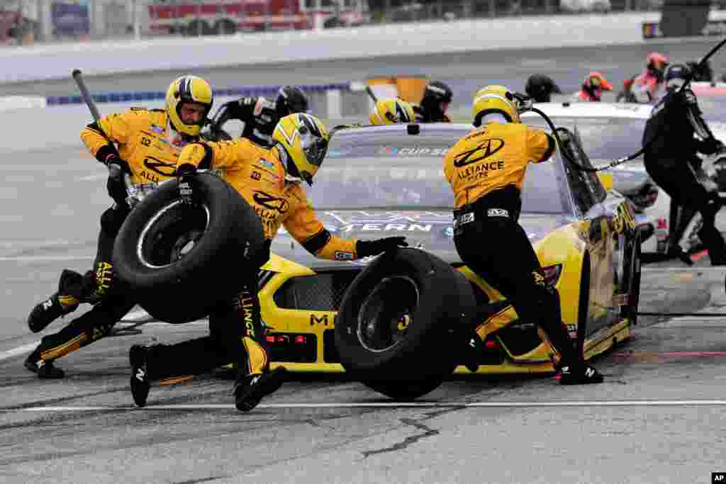 The pit crew scrambles as driver Brad Keselowski makes a pitstop during a NASCAR Cup Series auto race, Aug. 2, 2020, at the New Hampshire Motor Speedway in Loudon, New Hampshire.