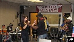 Members of Septo Tipico Tivoli teach students Cuban dances.