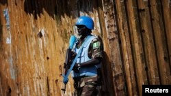 FILE - A Nigerian United Nations peacekeeper stands guard at a rally for incumbent Liberian President Ellen Johnson-Sirleaf in Monrovia.
