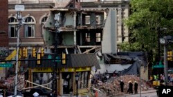 Firefighters view the aftermath of a building collapse in Philadelphia, Pennsylvania, June 6, 2013.