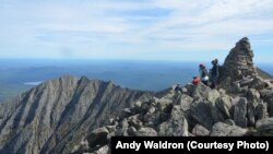 FILE - Appalachian Trail hikers are seen at the top of Mount Katahdin.