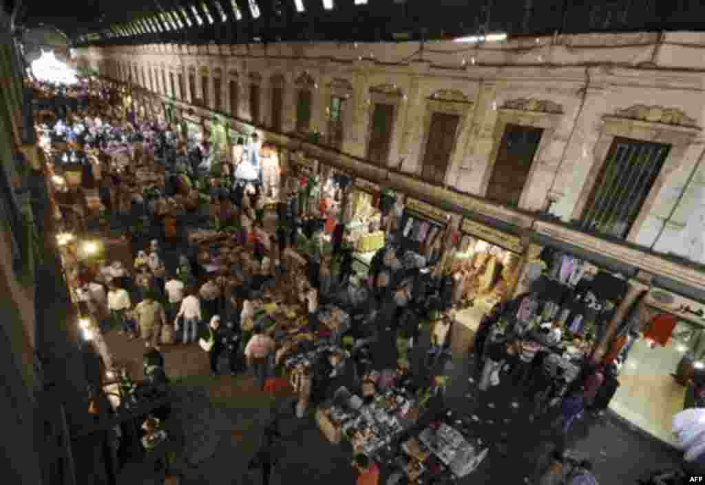Syrian citizens shop at Hamidiyeh popular old market, one day ahead of Eid al-Fitr that marks the end of the Muslim holy month of Ramadan, in the old city of Damascus, Syria, on Monday Aug. 29, 2011. Syrian security forces pursuing anti-government protest