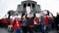 FILE - Stephanie Rolf, center, a teacher in the Douglas County, Colorado, school system, leads a cheer during a teacher rally in Denver, April 26, 2018.
